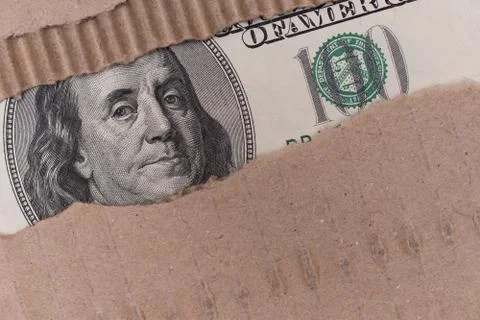 Benjamin Franklin macro through torn paper carton Photos