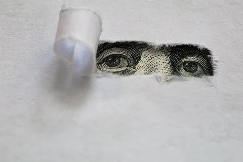 Benjamin Franklin peeking through torn white paper Stock Photos