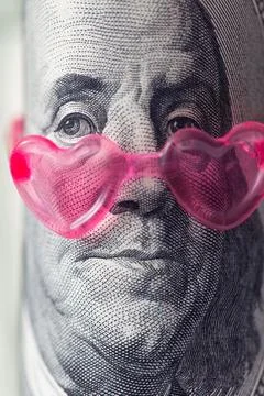 Benjamin Franklin from US 100 dollar banknote in pink heart sunglasses Stock Photos