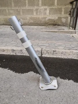Bent Parking restriction post. After a failed car Parking Stock Photos