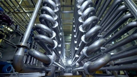 Bent pipes forming a double-sided corridor at a dairy factory. Stock Footage
