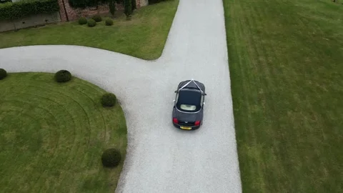 Bentley Driving Down Lane Approaching Wedding Venue at Kelmarsh Hall, England Stock Footage 303282625