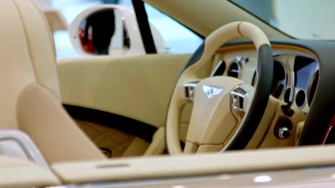Bentley luxury car interior with leather steering wheel and dashboard Stock Footage 334671410