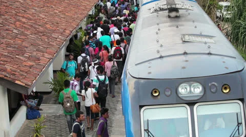 Bentota, sri lanka - may 02: passengers board the train on the station on may Stock Footage