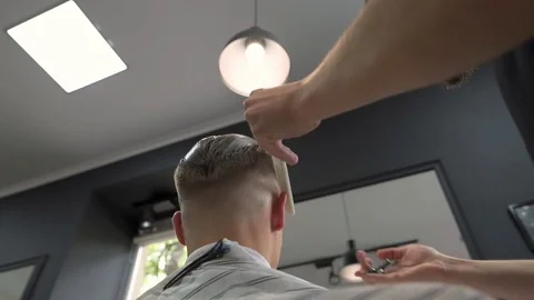 Berber shears a client with scissors using a comb, a bottom view Stock Footage 80582370