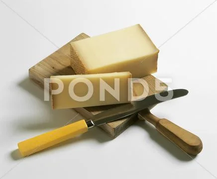 Bergkäse (Alpine cheese) on wooden board Stock Photos