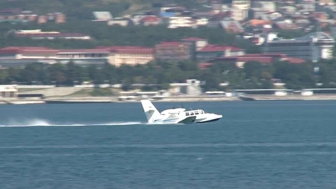 Beriev Be-103 light amphibious aircraft accelerates through water and takeoff. Stock Footage 120777293