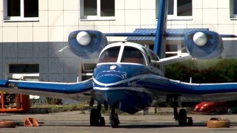 Beriev Be-103 light amphibious aircraft steers from parking lot. Stock Footage 120777351