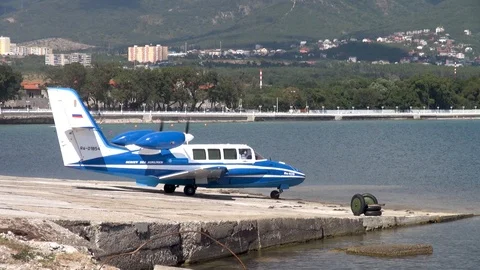 Beriev Be-103 Russian light amphibian aircraft moves from parking lot to sea. Stock Footage 123210343