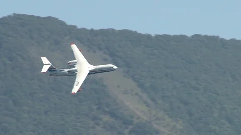 Beriev Be-200ES - multi-purpose amphibious aircraft performs aerobatics over sea Stock Footage 120497796