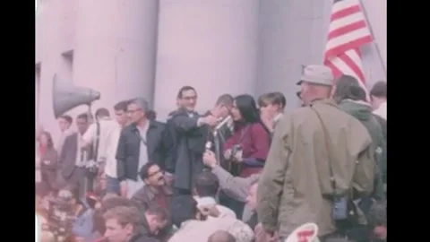 BERKELEY - 1964 - A man holds a microphone as Joan Baez plays the guitar as she Vidéo 340651066