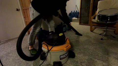 Berkeley Heights, NJ, USA - 10-26-2021: woman vacuuming water after flood Stock Footage 284989415