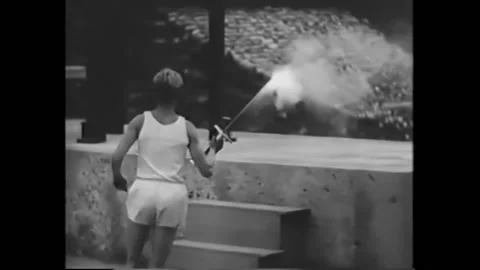 BERLIN - 1936 - The Olympic flame is lit at Berlin's Olympic Stadium, where Stock Footage 272365706