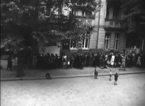 BERLIN - 1946: Bread line - Long civilian queue waits outside a bakery Stock Footage 344495833