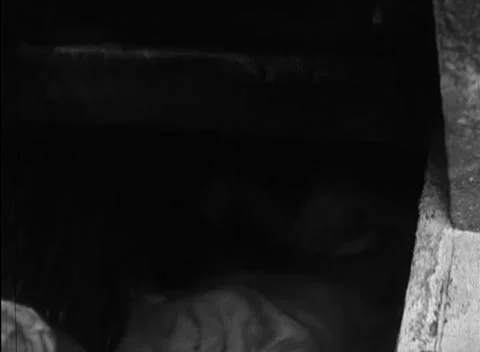BERLIN - 1946: Dark storeroom - Sack lies in a dark storage recess 库存影片 344495962