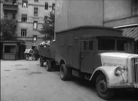BERLIN - 1946: Delivery - Carcass trailer stands beside a box truck Stock Footage 344495831