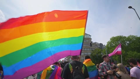 Berlin - 22.07.2023. Pride activists marching with LGBT flag in the city Stock Footage 323461781