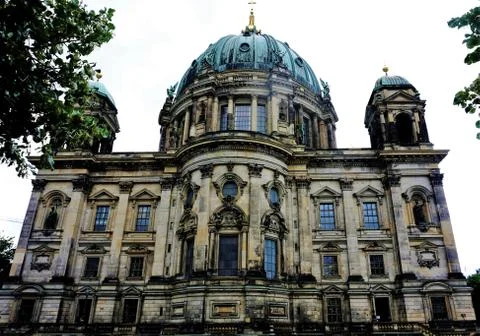 The Berlin cathedral behind trees Stock Photos