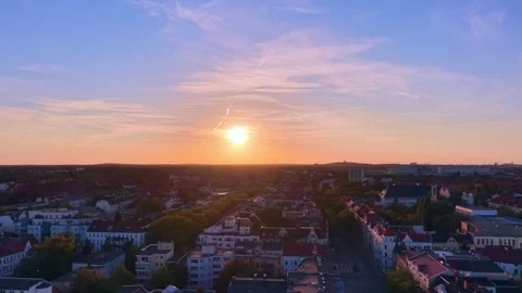 Berlin cityscape at Solar Eclipse golden hour with setting sun. Lovely aerial Stock Footage 344496620
