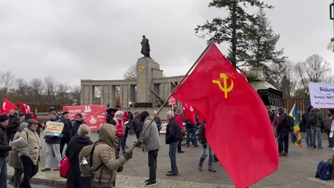 Berlin: Communist sympathiser waves Soviet flag during demo at War Memorial, 4K Stock Footage 256472478