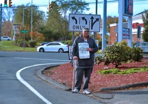 Berlin, CT USA. Nov 2019. Disabled and homeless veteran on street with aid si Stock Photos