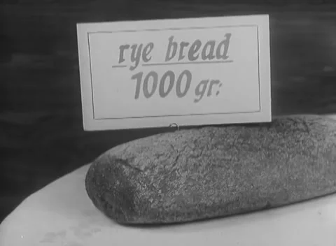 BERLIN, GERMANY - 1946: Staple rations - Rye bread, pasta and salt displayed 스톡 동영상 344495651