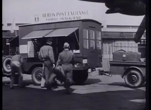 BERLIN, GERMANY - 1949: Canteen - Mobile snack bar beneath aircraft wing Stock Footage 344496384