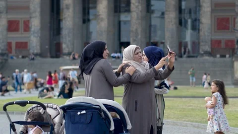 BERLIN, GERMANY - 23 JUN 2018: Muslim women with children visiting the sights of Stock Footage 98340402