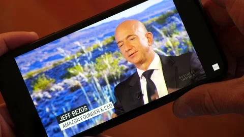 Berlin, Germany - 5 May 2018: Jeff Bezos Interview about Amazon. Watching the Stock Footage 144935725