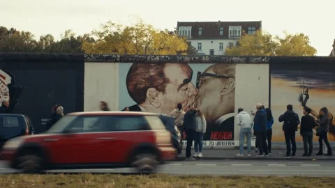 Berlin, Germany: Berlin Wall graffiti art, Leonid Brezhnev and Erich Honecker Stock Footage 276373910