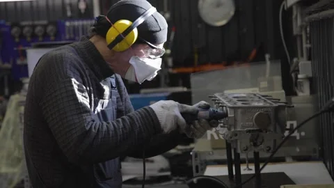 Berlin. Germany, CIRCA 2022. Engineer repairs a car engine in his garage wearing Stock Footage 194551360