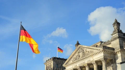 BERLIN GERMANY German flags fluttering in the wind and building of Reichstagin Stock Footage 127154135