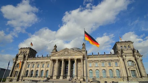BERLIN GERMANY German flags fluttering in the wind and building of Reichstagin Stock Footage 127154144