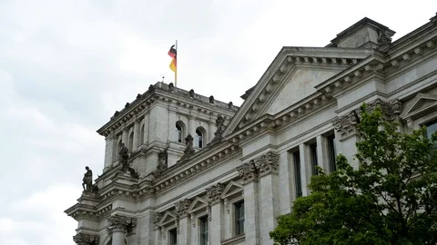 BERLIN, GERMANY. German flags fluttering in the wind in back side of Reichstagin Stock Footage 127154398