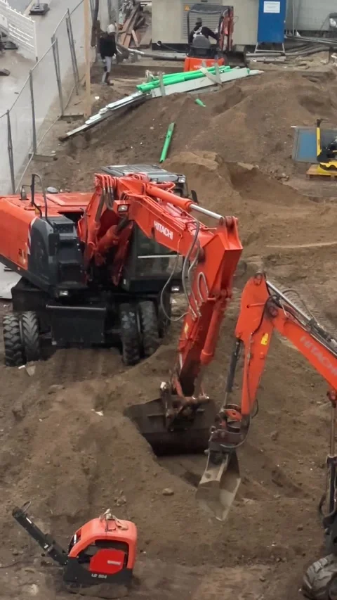 Berlin, Germany, March 2, 2026: an orange excavator operating Stock Footage 331816467