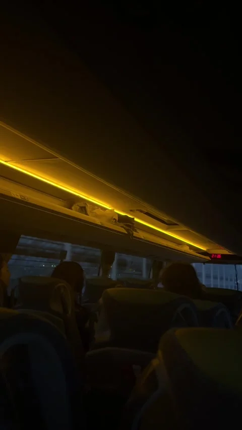 Berlin, Germany - May 23, 2026 - coach interior during evening journey, warm Stock Footage 336720458