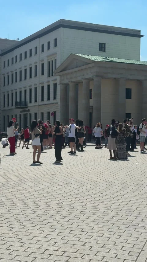 Berlin, Germany - May 23, 2026 - people gathering in sunny urban public square, Stock Footage 337191292