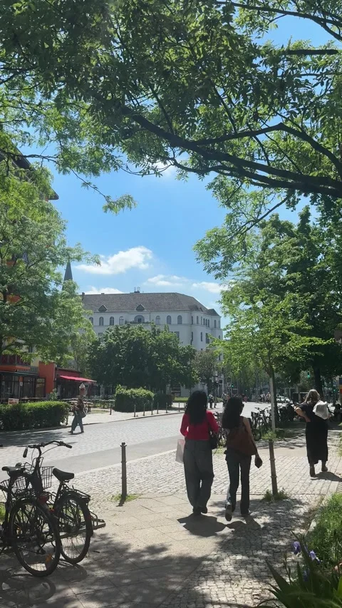 Berlin, Germany - May 23, 2026 - pedestrian movement along sunlit urban street Video stock 337662788