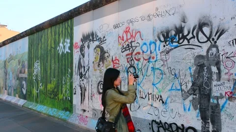 Berlin Germany remaining part of Berlin Wall with Chinese tourist with artists Stock Footage 47341349