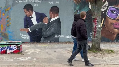 Berlin - Graffiti at Mauerpark depicts Will Smith slapping Chris Rock, 4K Stock Footage 173164494