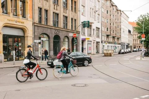 Berlin, October 2, 2017: Two young unknown girls riding bicycles along the Stock Photos