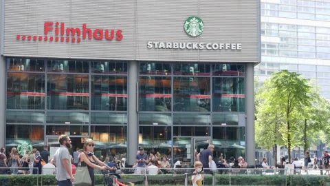 Berlin open space surrounded with shopping center mall, starbucks cafe, and Stock Footage 138736304