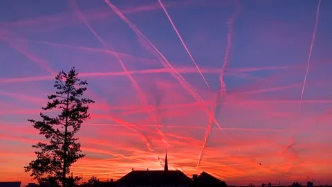 Berlin: Sunset with condensation trails in a beautiful colorful sky, 4K Stock Footage 303834143
