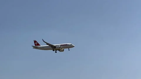 Berlin: A Swiss Airbus A320 jet approaches Berlin Airport for landing, 4K Stock Footage 201513769