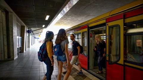 Berlin - Train arrives at the S-Bahn station, with travelers getting on and off Stock Footage