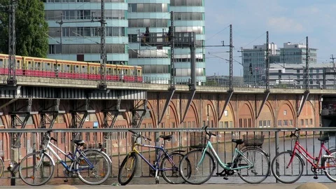 Berlin train goes on it's route with bicycles in front, and traffic passes by. Video stock 98318369
