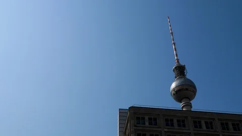 Berlin TV tower pan shot from Alexander Platz with blue sky Stock-Footage 116245342