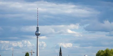 Berlin TV Tower with panoramic cloudy sky and city elements 스톡 사진