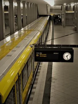 Berlin u-bahn yellow train stopping at platform Stock Photos