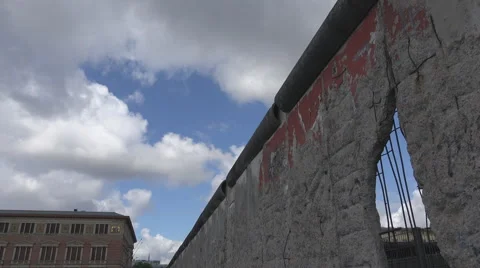 Berlin wall dramatic symbol hole concrete historic barrier protection west east  Stock Footage 40491813